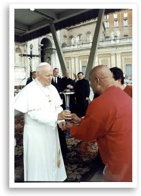 Pope John Paul II holds the Peace Torch